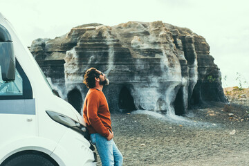 Wall Mural - One driver man standing outside the vehicle and enjoying freedom outdoors. Travel camper van lifestyle people. Traveler resting in scenic destination. Motor home free nature parking. Vanlife tourism