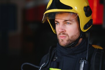 Wall Mural - Photo of fireman with gas mask and helmet near fire engine