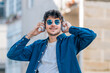 © carballo - boy on the street with headphones and sunglasses