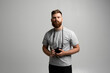 © Volodymyr - Young bearded proffesional photographer man with a dslr camera over white background.