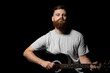 © Volodymyr - Bearded brutal guitarist plays an acoustic guitar in a black room. The concept of music recording, rehearsal or live performance.