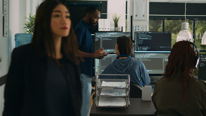Software programmers talking about algorithms on big screen and tablet, analyzing html script language. Team of system engineers discussing database on terminal window, server interface.