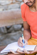 © Sangiao_Photography - Indian mid adult south asian handsome man write outdoor on travel diary in Asturias, Spain