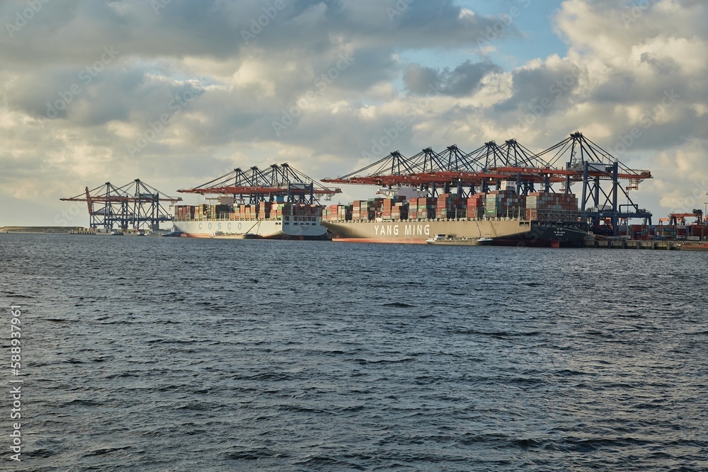Loading containers on a ship Stock Photo | Adobe Stock