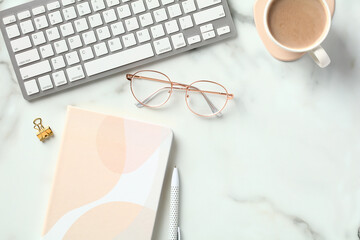 Fototapete - Modern office desk table top view. Flat lay keyboard, cup of coffee, paper notebook, glasses on marble background.