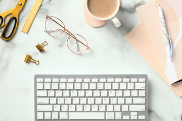 Fototapete - Stylish office desk table with keyboard, paper notebooks, cup of coffee, glasses, stationery on marble background