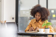 © David - Young business Asian woman african freelancer is working her job on a laptop computer in modern office. Doing accounting analysis report real estate investment data, Financial and tax systems concept