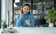 © Orathai - Happy Asian girl wearing headphones listening to music enjoy on smartphone digital. relaxation concepts