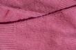 Lints on pink sweater. Acrylic or wool sweater. Before cleaning and collected fluff lint. Closeup Pilled sweater. Old used sweater with lint pilling. Restoration of old damaged clothes care. Repairing