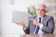 © Elnur - Old male employee working in the office
