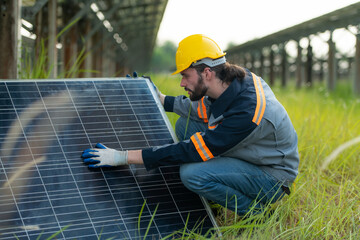 An electrical engineer is inspecting a solar cell that has been used for some time, installed on a field hundred acres of grass.