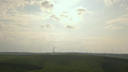 Wall Mural - Drone view of wind farm generating alternative green energy. Wind turbines rotating at windmill park in mountain.