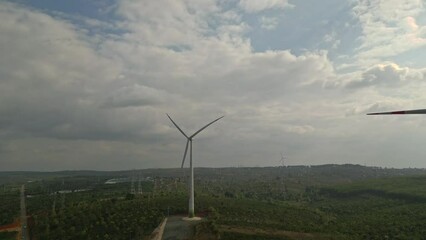 Wall Mural - Drone view of wind farm generating alternative green energy. Wind turbines rotating at windmill park in mountain.

