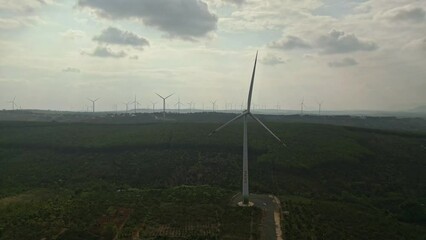 Wall Mural - Drone view of wind farm generating alternative green energy. Wind turbines rotating at windmill park in mountain.

