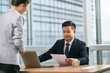 © imtmphoto - asian business manager reviewing a document in office