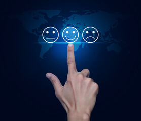 Hand pressing excellent smiley face rating icon over digital world map technology style, Business customer service evaluation and feedback rating concept, Elements of this image furnished by NASA