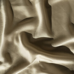 Crumpled golden glossy silk cloth background