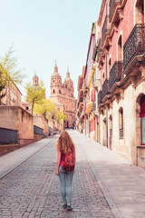 Wall Mural - Woman walking in the street of Salamanca with cathedral view in the background- Spain