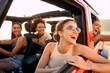 © Monkey Business - Group Of Laughing Female Friends Having Fun In Open Top Car On Road Trip