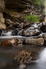 Wall Mural - Long exposure of a river in a green forest