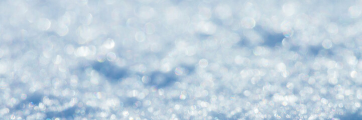 Wall Mural - Snow surface close-up. Winter background with snow texture and beautiful bokeh. Shallow depth of field and blur. Perfect for Christmas and New Year design. View with copy space.