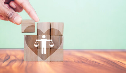 Wall Mural - Ethical corporate culture concept. Ethics inside human heart. Business integrity and moral. Placing wooden cubes with ethics inside a heart on smart background. Sustainable business development