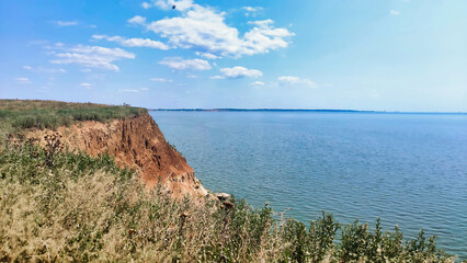 Wall Mural - View of the Black Sea and clay slopes with grass on the island of Berezan. Ukraine. Europe