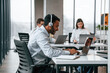 © standret - Everyone is using laptop. Men and woman are working in the office together