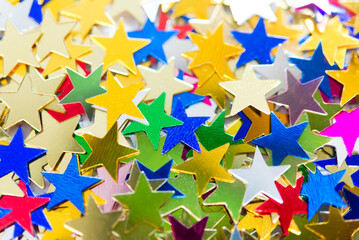 Wall Mural - Multi-colored shining stars close-up. Festive holiday background.