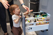 © Ana Blazic Pavlovic - One year old child looking trough the kitchen drawer