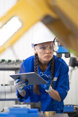 Robotic engineer monitoring robot arm connection for maintenance in science laboratory. Modern smart women get training industry 4.0 automated engineering in futuristic electronic technology academy.