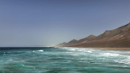 Wall Mural - View from above, stunning aerial view of Cofete beach surrounded by the chain of mountains of the Jandía Natural Park. Fuerteventura, Canary Islands.