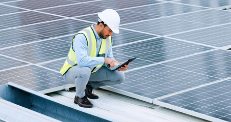 Aufkleber - Young engineer or contractor inspecting solar panels on a roof in the city. One confident young manager or maintenance worker smiling while installing power generation equipment and holding a tablet