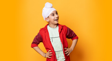 indian kid standing and smiling with hand on waist
