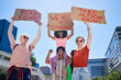 © Caia Image - Portrait young protester friends holding equal rights signs in city