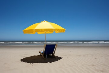 Yellow umbrella and beach background with empty blue sunbeds.