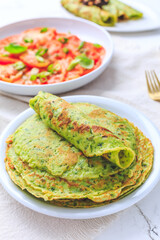 Wall Mural - Savory wild garlic pancakes with tomato salad