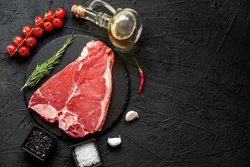 Wall Mural - raw T-bone steak on stone background with copy space for your text