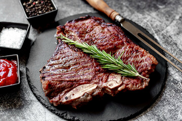 Poster - grilled T-bone steak on stone background