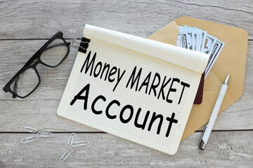 MONEY MARKET ACCOUNT open notepad with text on an envelope with money