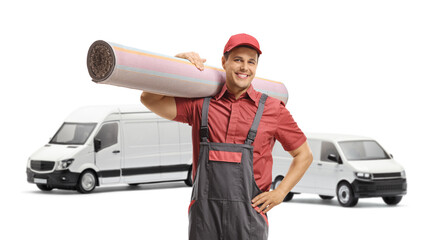Wall Mural - Male worker carrying a carpet in front of two ehite vans