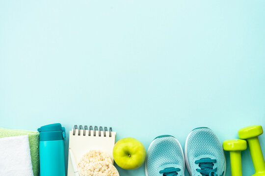 Fitness, workout, healthy lifestyle and clean eating concept. Top view on blue background.