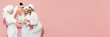 © master1305 - Three emotional, happy, beautiful young girls in bathrobes drinking champagne, having fun against pink background. Concept of youth, beauty, friendship, party, relaxation. Copy space for ad. Banner