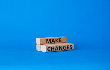 Wall Mural - Make changes symbol. Wooden blocks with words Make changes. Beautiful blue background. Business and Make changes concept. Copy space.
