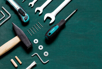 Wall Mural - Set of professional tools for renovation or home repairs on the green wooden background. Copy space