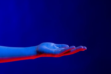 Wall Mural - Exposed hand in studio with blue light with copy space