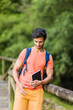 © Sangiao_Photography - south asian 40s male hiking with a backpack in Asturias green countryside with a diary in spain.