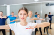 © JackF - Young smiling woman practicing vigorous lindy hop movements in dance class