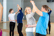 © JackF - Mature dancing couple enjoying social dance during group class in modern studio