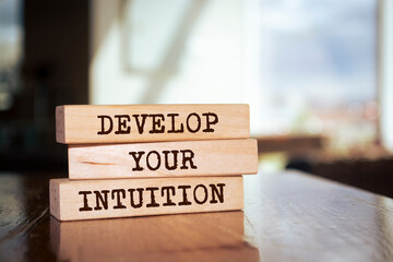 Poster - Wooden blocks with words 'DEVELOP YOUR INTUITION'.